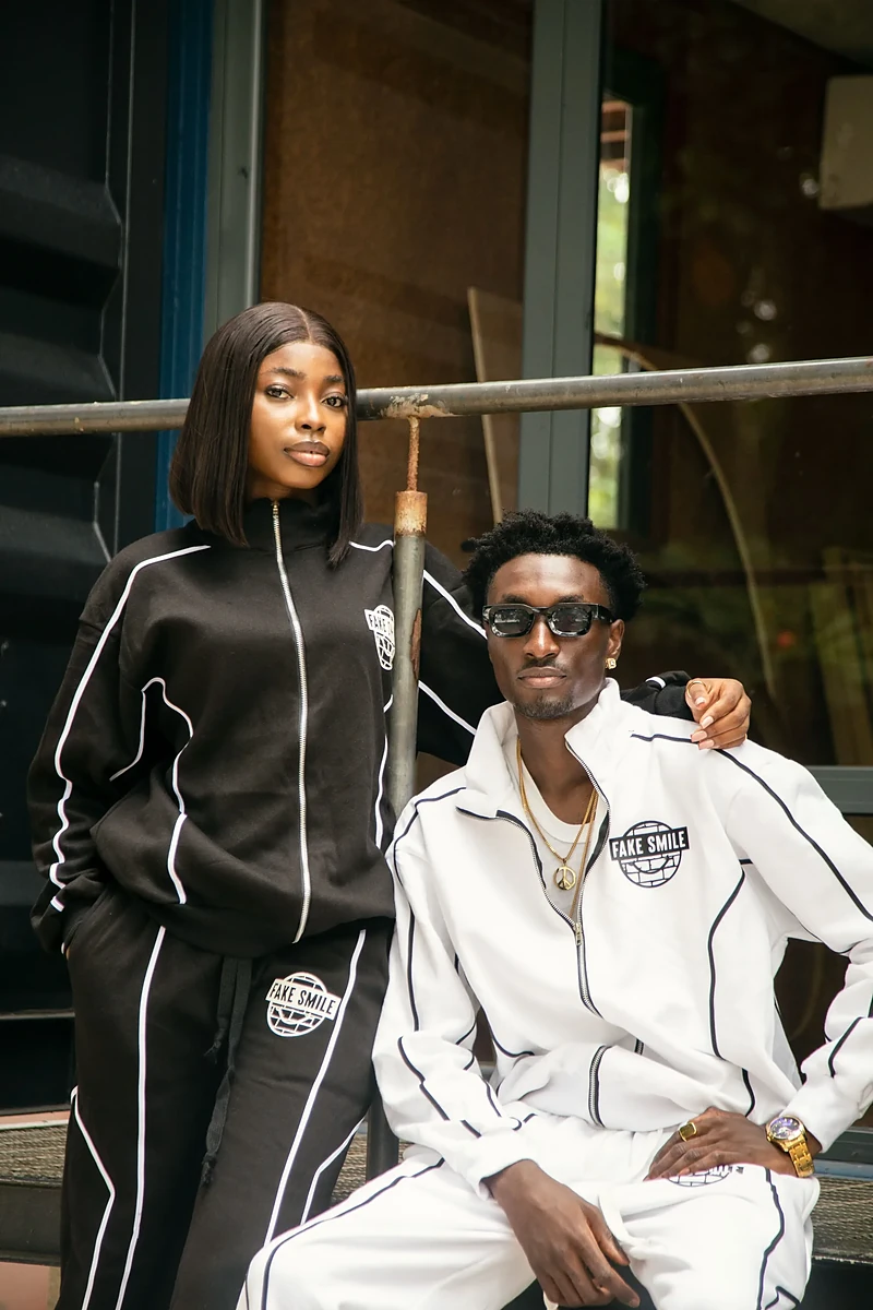Two FakeSmile customers in matching tracksuits — real fits from the crew