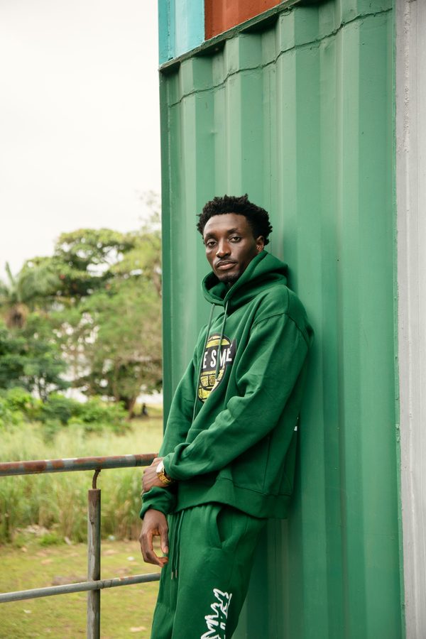 FakeSmile model in green hoodie