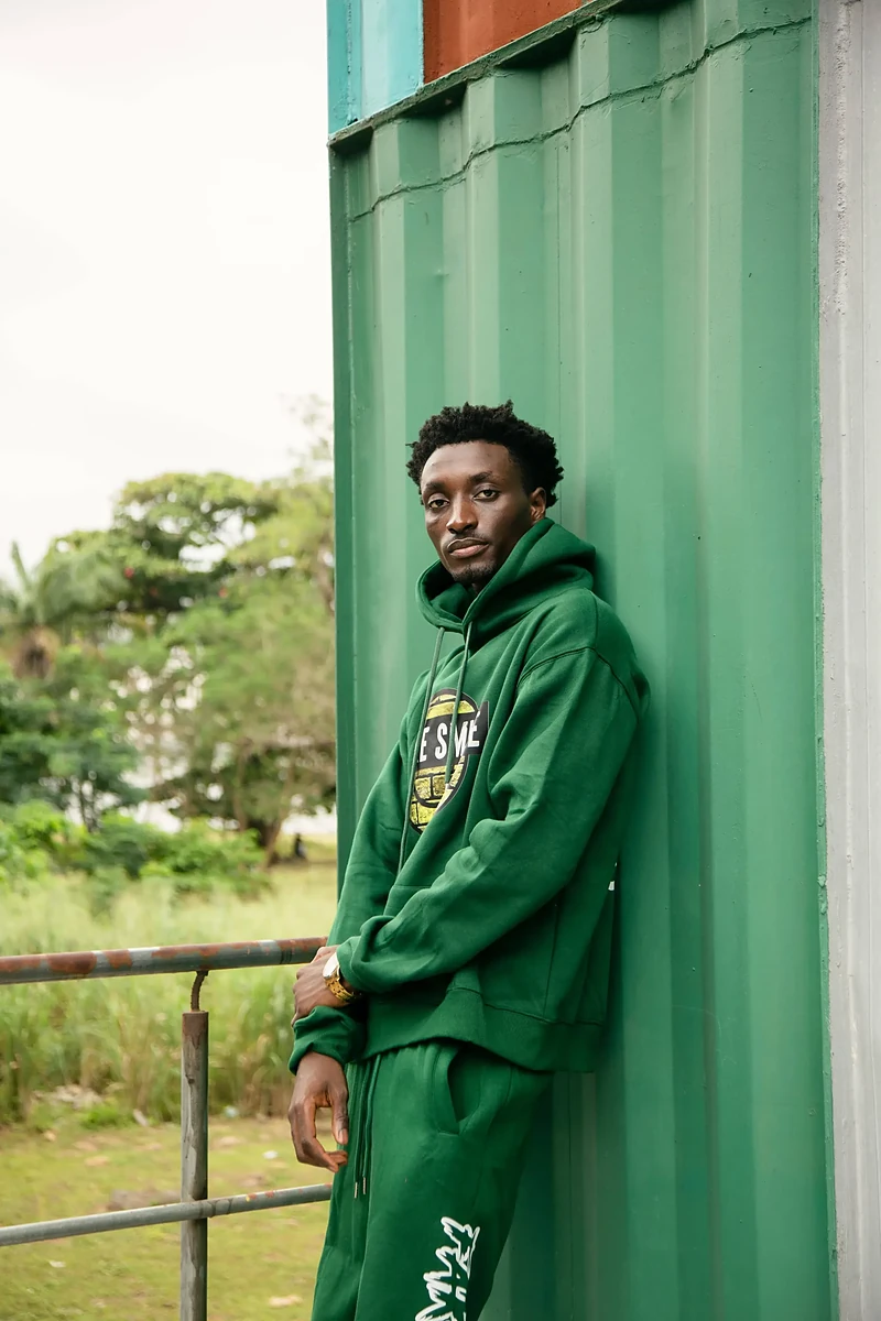 FakeSmile model in green hoodie